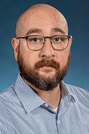 Bald man with glasses and beard.