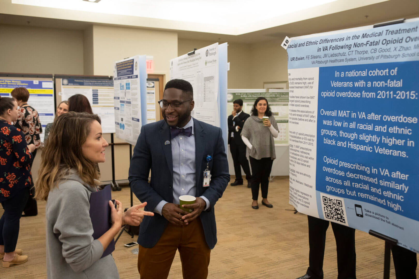 Researchers chatting at academic poster session