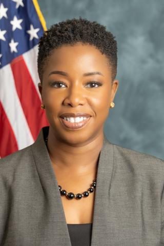 Smiling woman in blazer with American flag