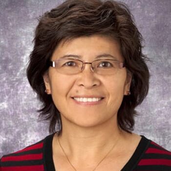 Smiling woman wearing glasses and striped shirt