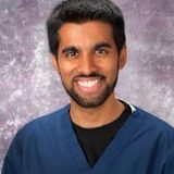 Smiling man in blue medical scrubs portrait