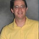 Smiling man in yellow polo shirt